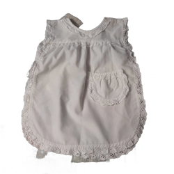 Baby white vintage smock bib eyelet  with bow side closer and velcro made in Scotland by Sanderson Kemp.